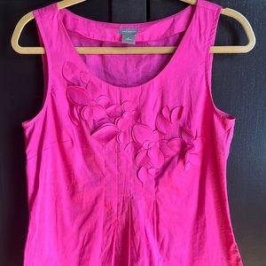 Sleeveless bright pink and Taylor blouse with cut flower detail.